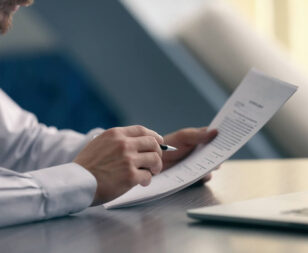 men are looking at the documents to analyze problems and find solutions before bringing the information to a meeting